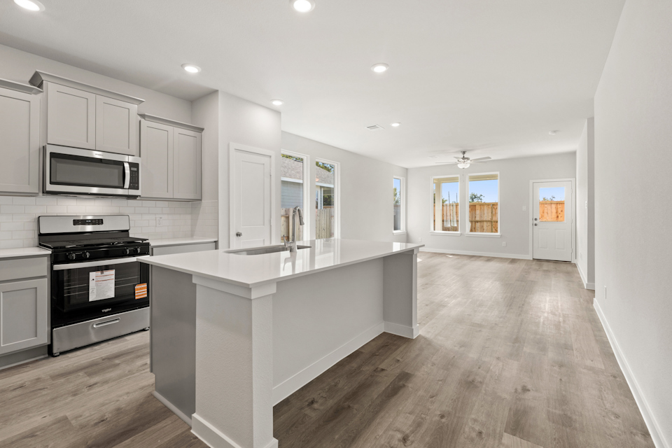 A kitchen with white cabinets.