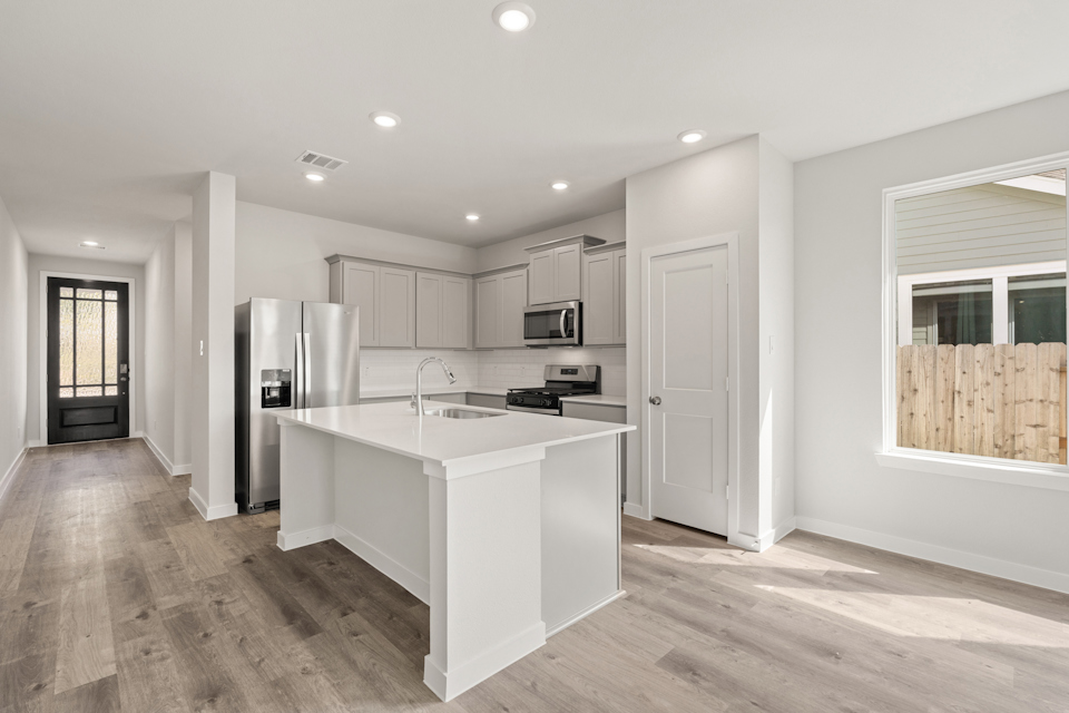 A kitchen with white cabinets.