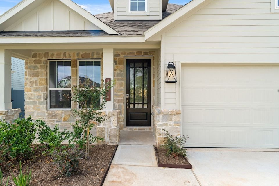 A house with a garage and a door.