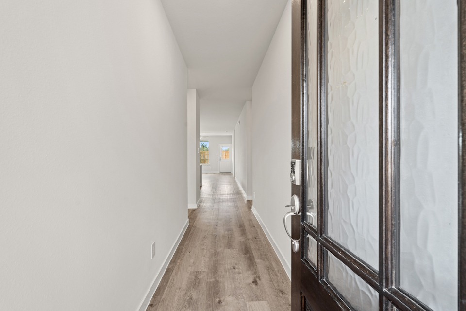 A hallway with white walls.