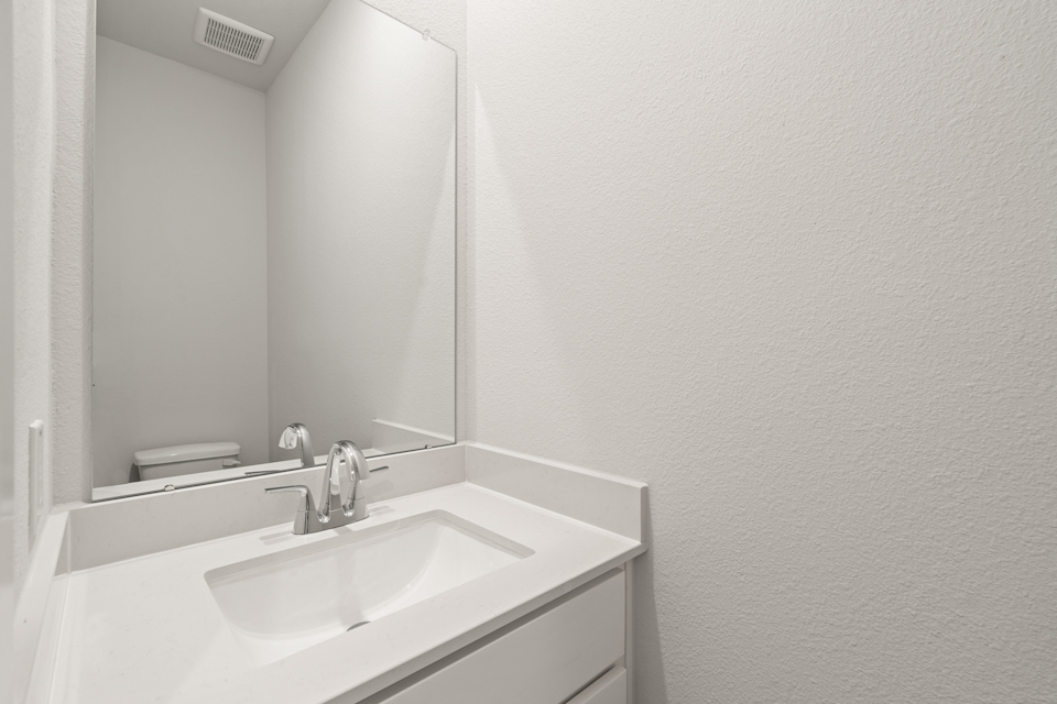 A bathroom with a sink and a mirror.
