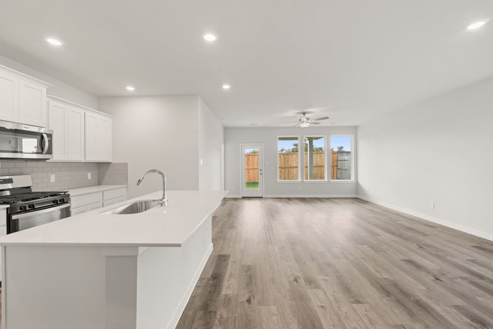 A kitchen with white cabinets.