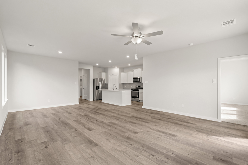 A large kitchen with a ceiling fan.