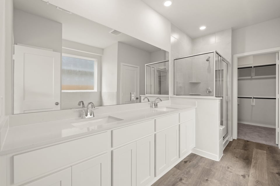 A bathroom with white cabinets.