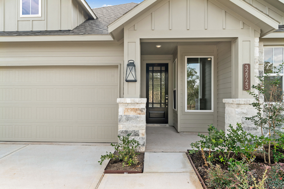 A house with a garage and a door.