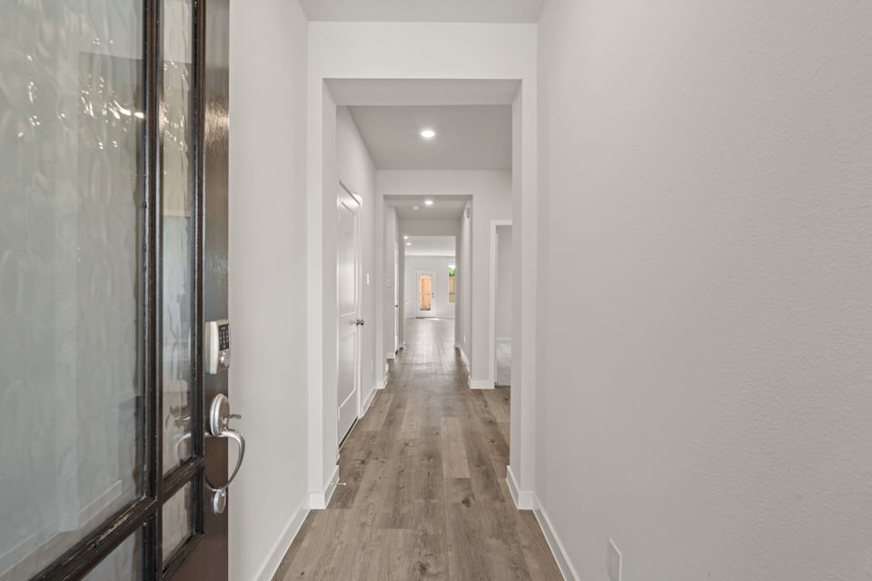 A long hallway with glass doors.