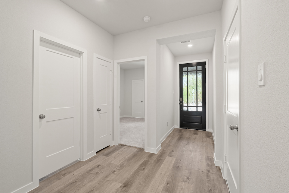 A hallway with white doors.