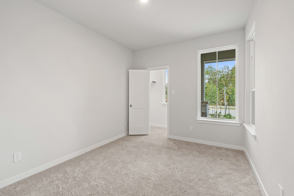 A room with a window and a door.