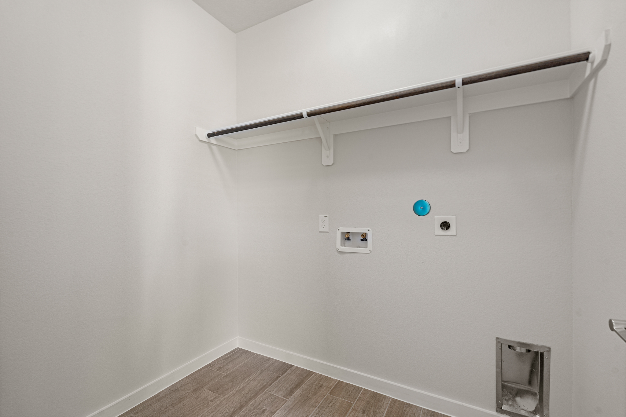 A white wall with a light fixture.