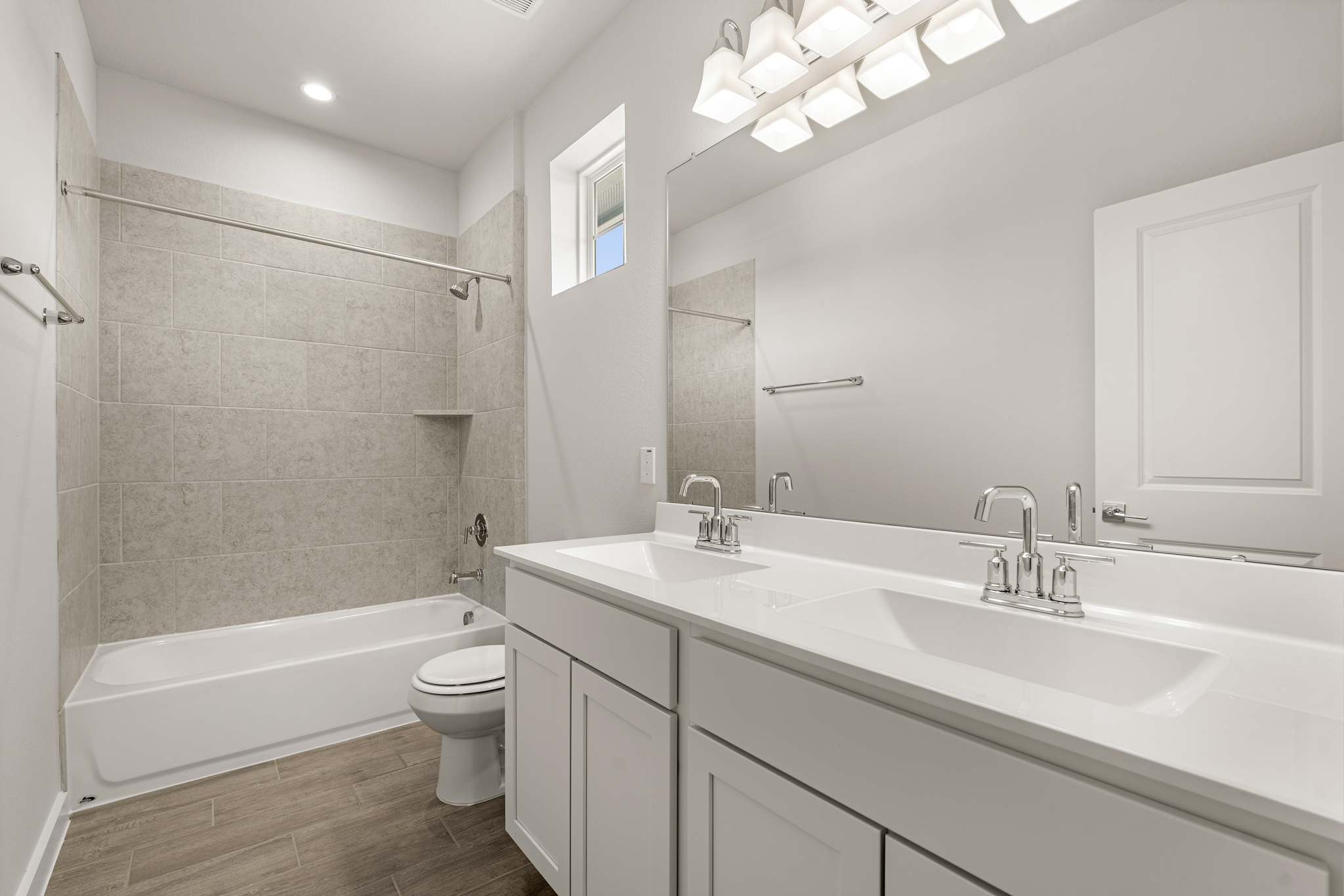 A bathroom with a tub sink and toilet.
