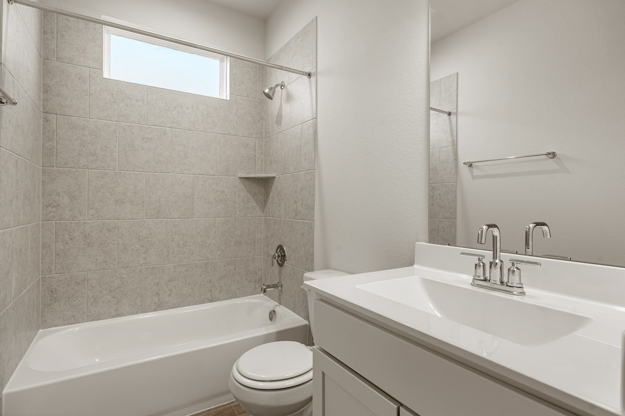 A bathroom with a tub sink and toilet.