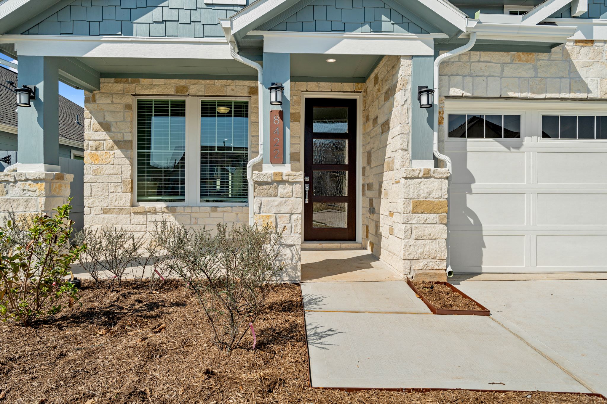 A house with a garage and a door.