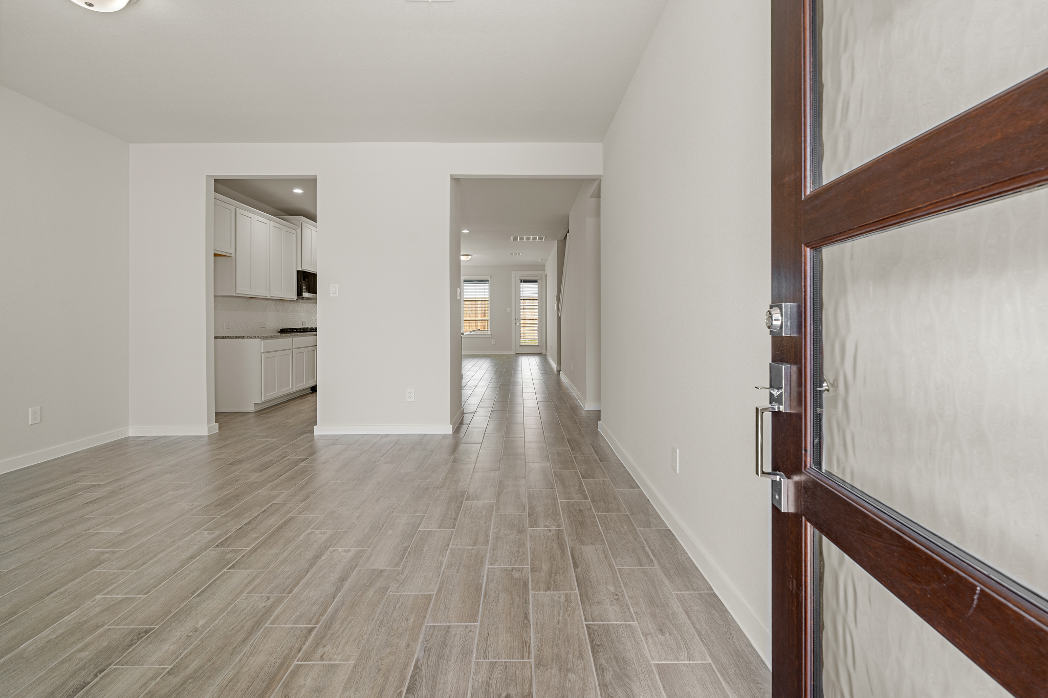 A hallway with wood floors.