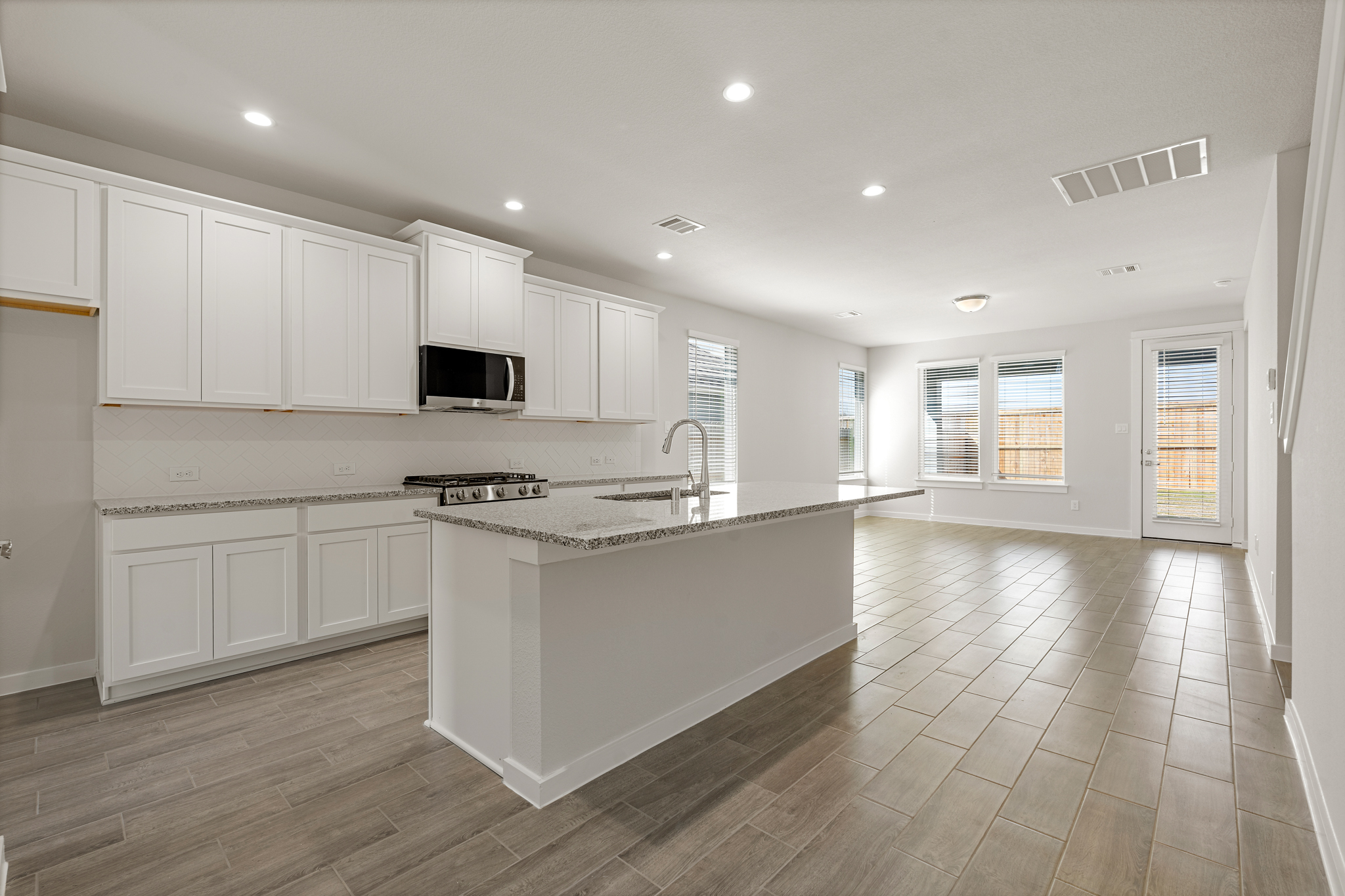 A kitchen with white cabinets.