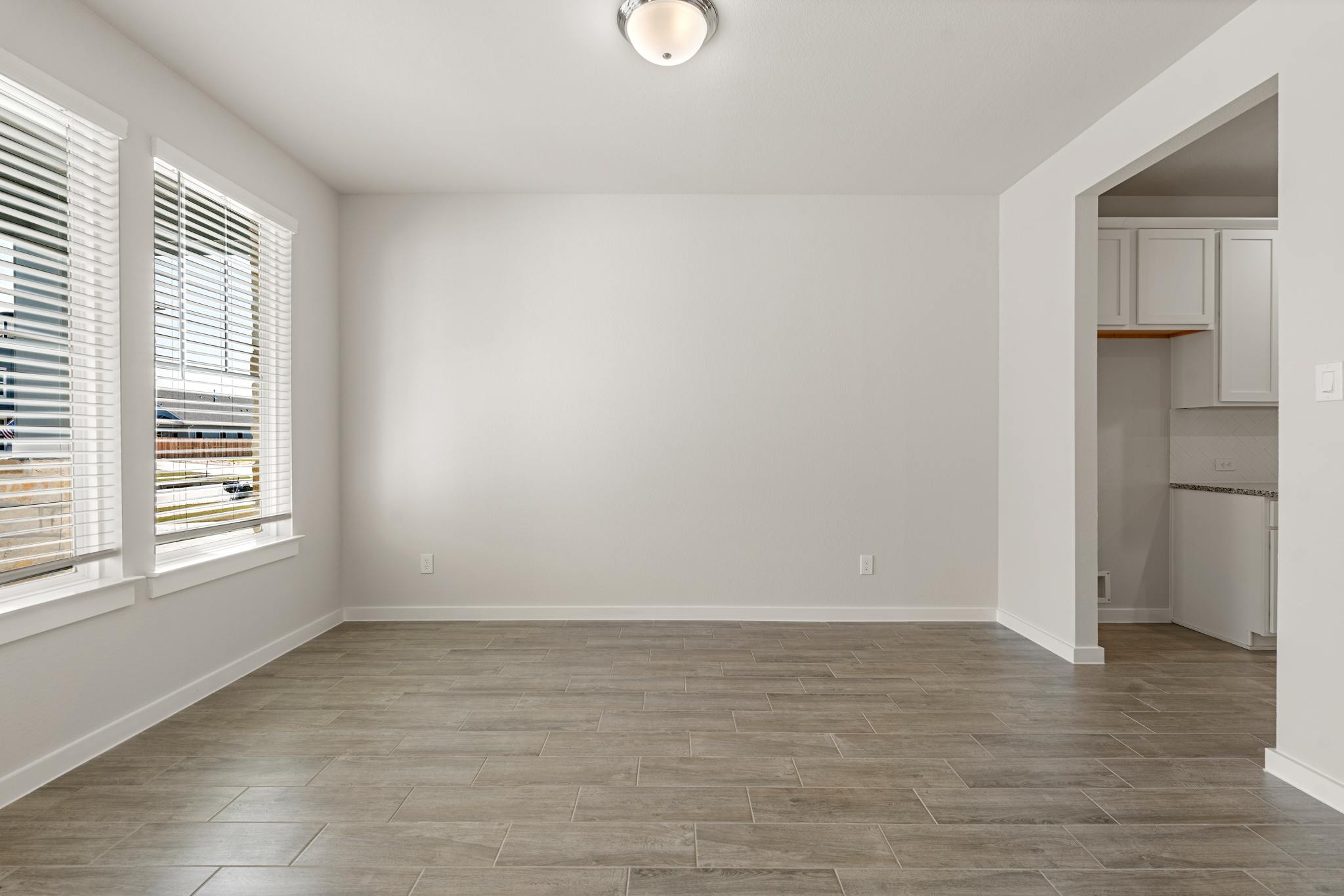 A room with a tile floor and a window.