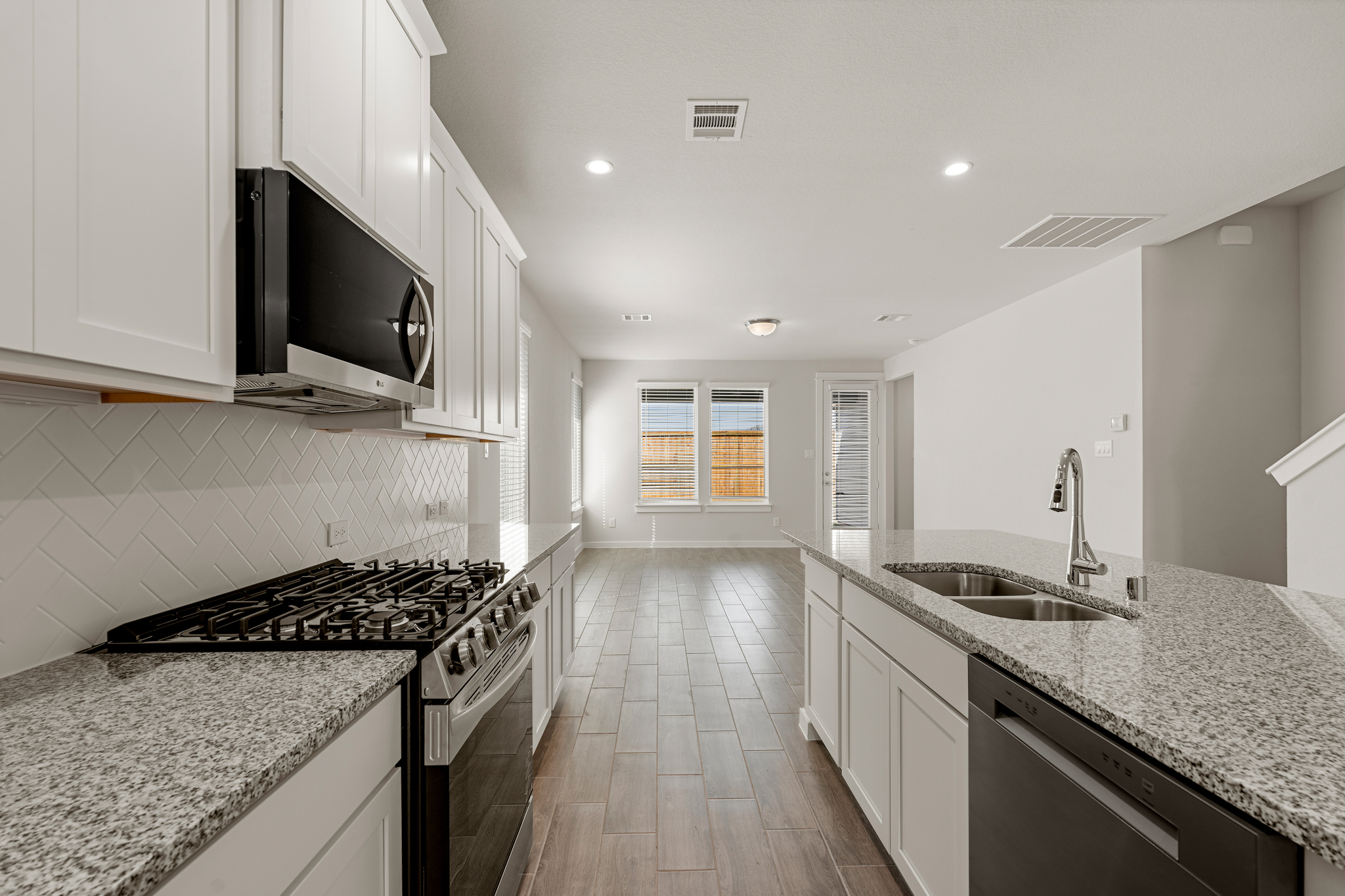 A kitchen with marble counters.