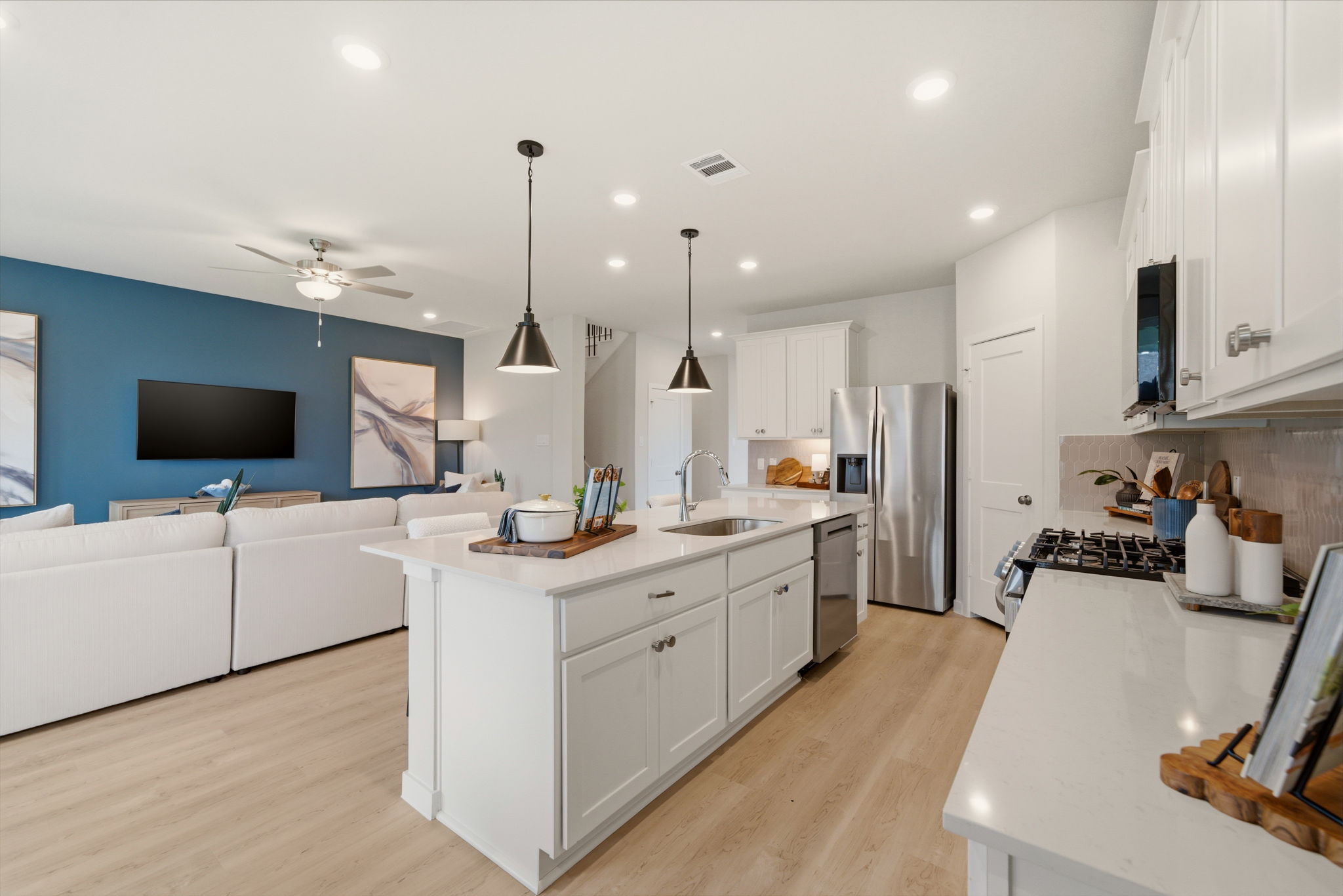 A kitchen with white cabinets.
