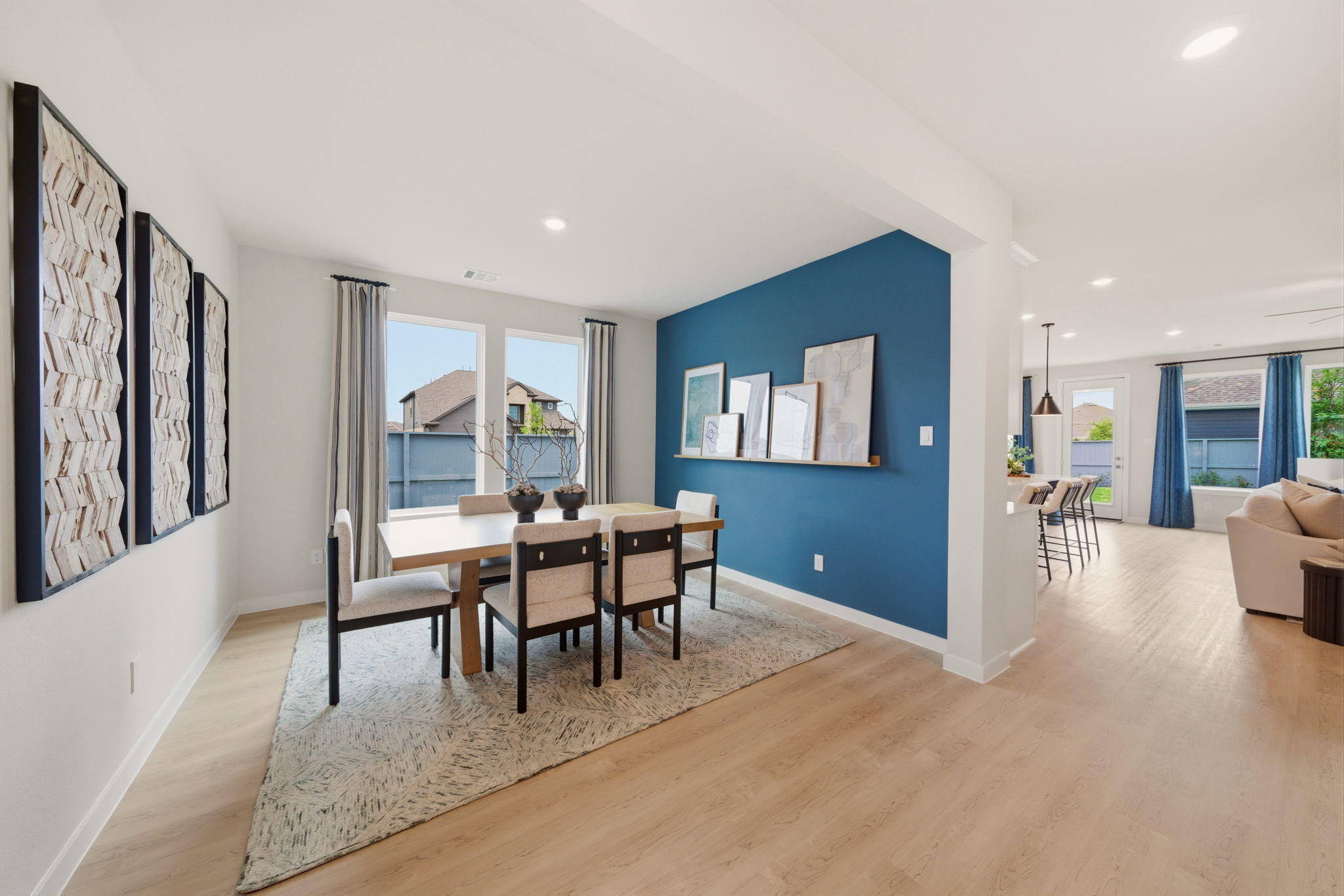 A dining room with a large table.