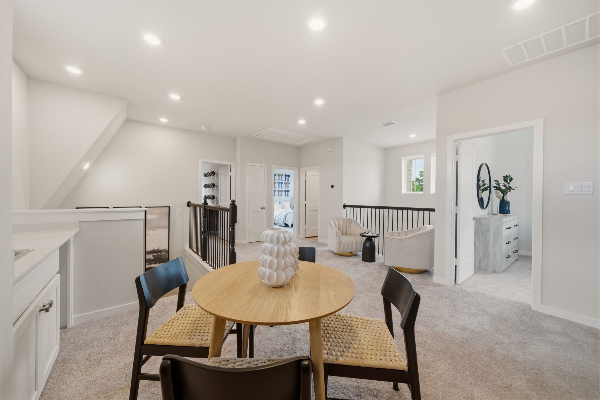 A dining room with a table and chairs.