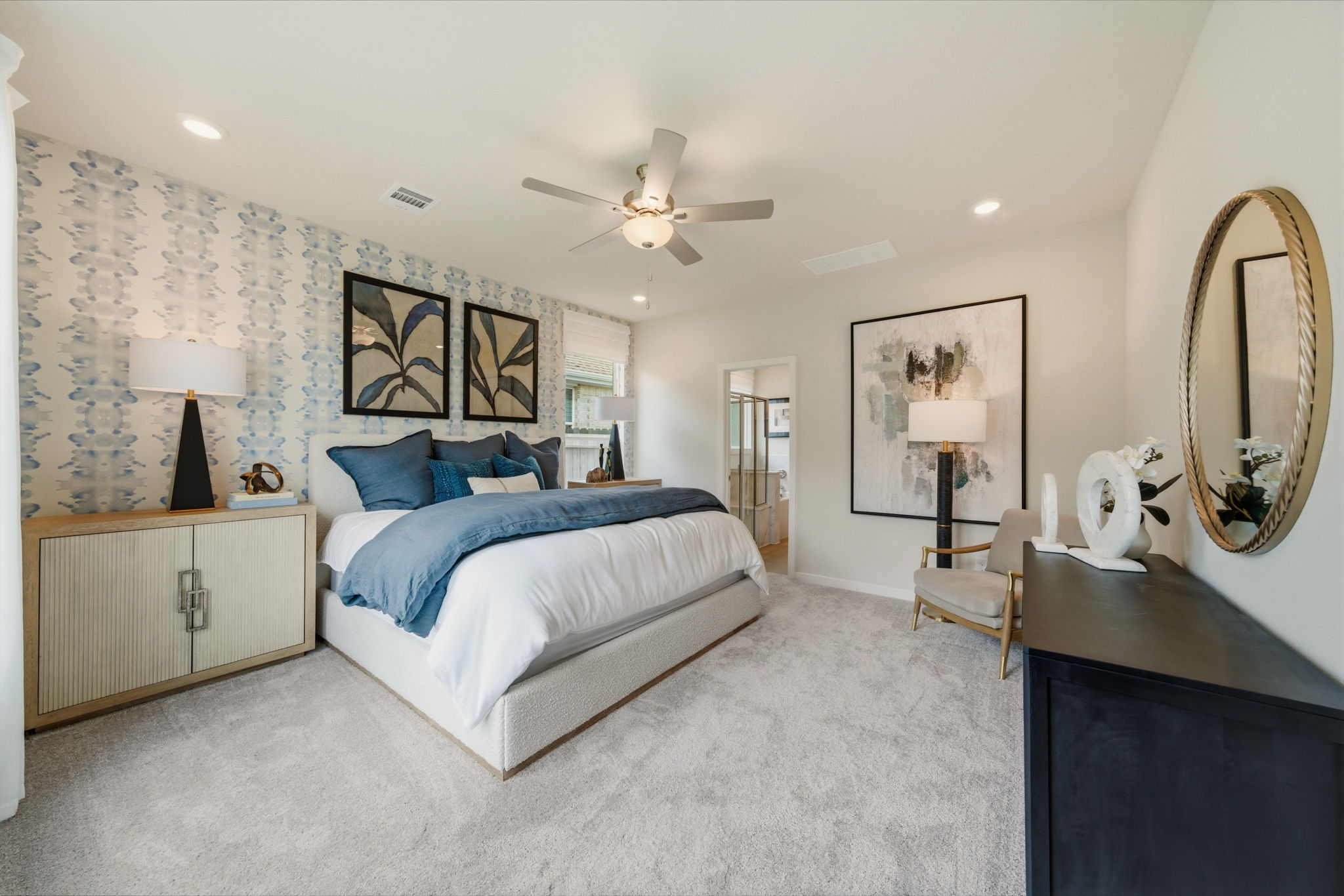 A bedroom with a large mirror.