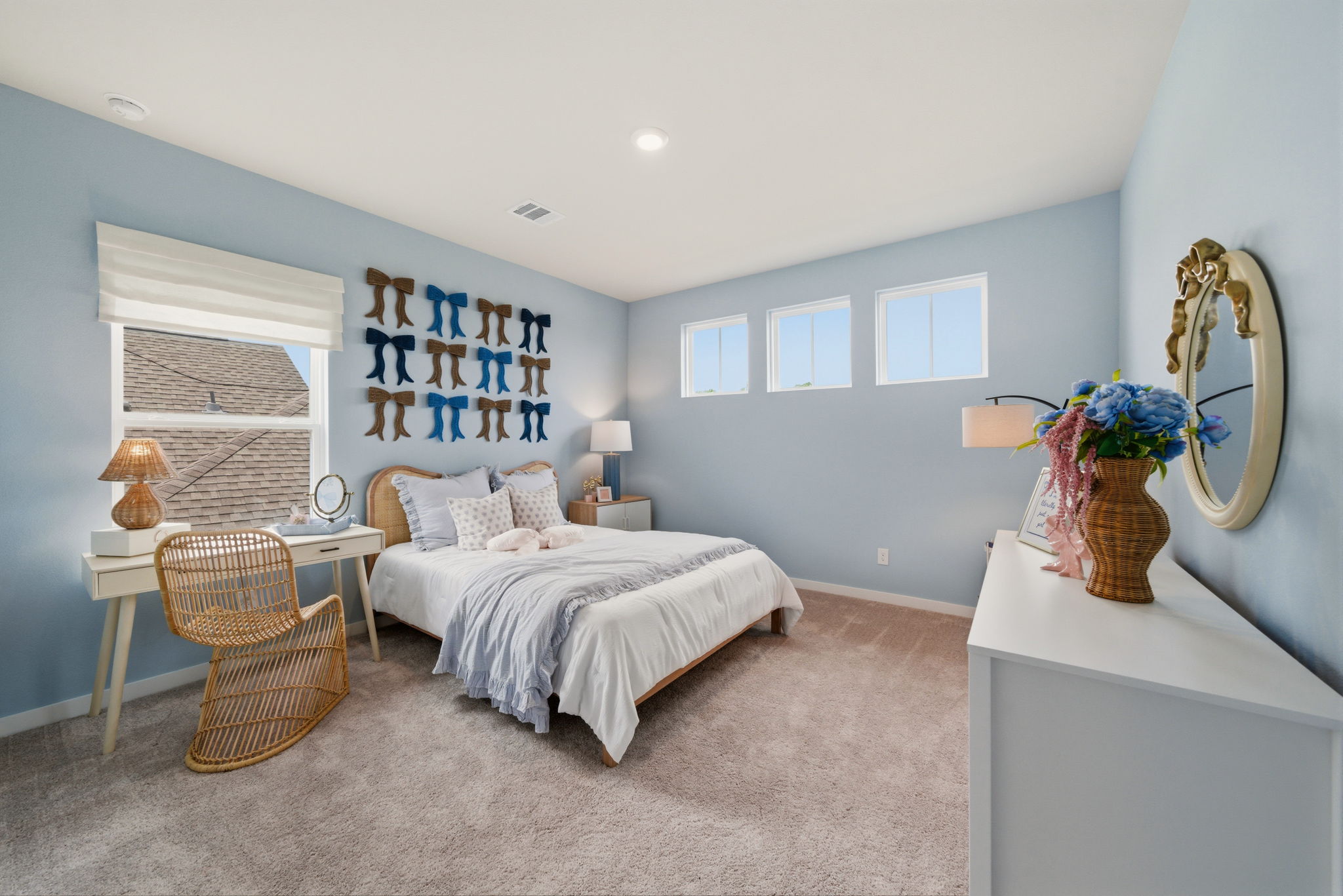 A bedroom with a bed and a chair.