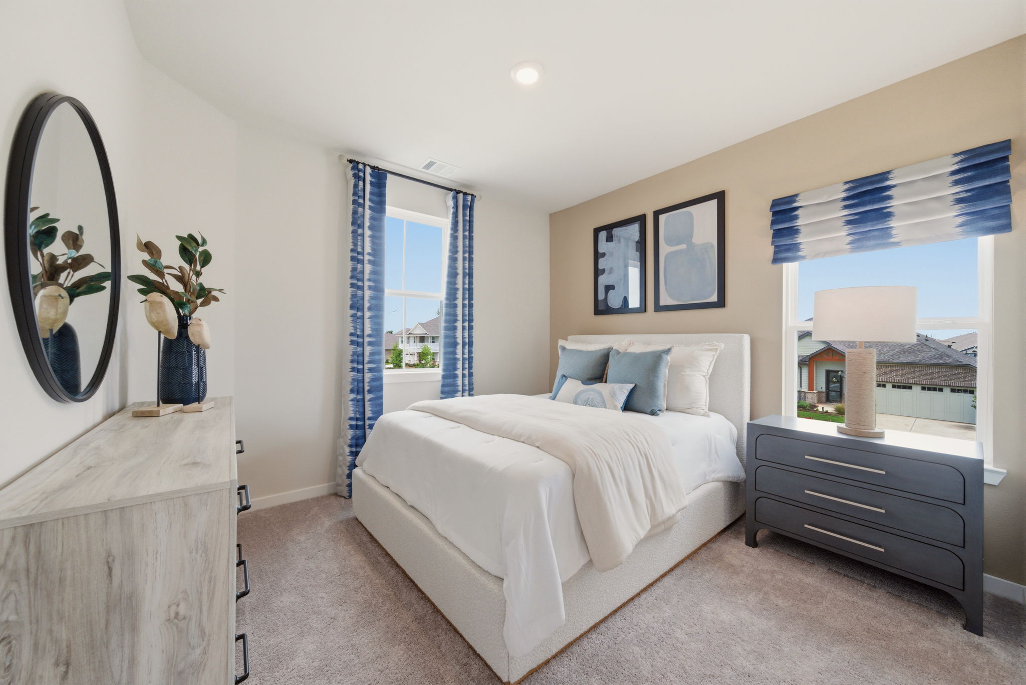 A bedroom with a bed and a dresser.