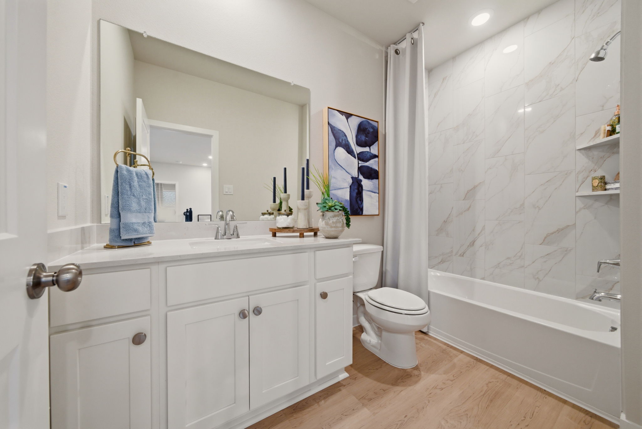A bathroom with a tub toilet and sink.