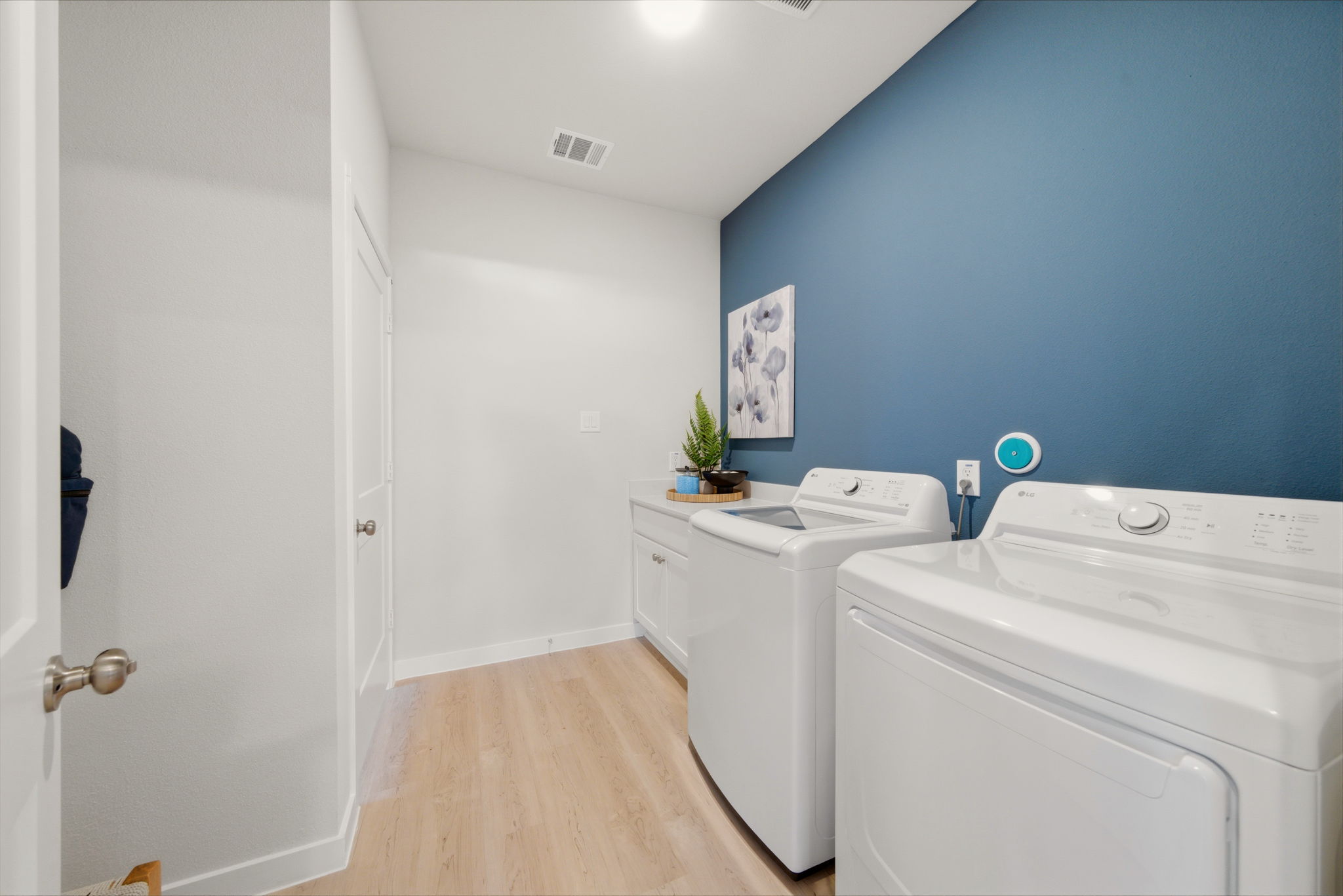 A room with a washer and dryer.