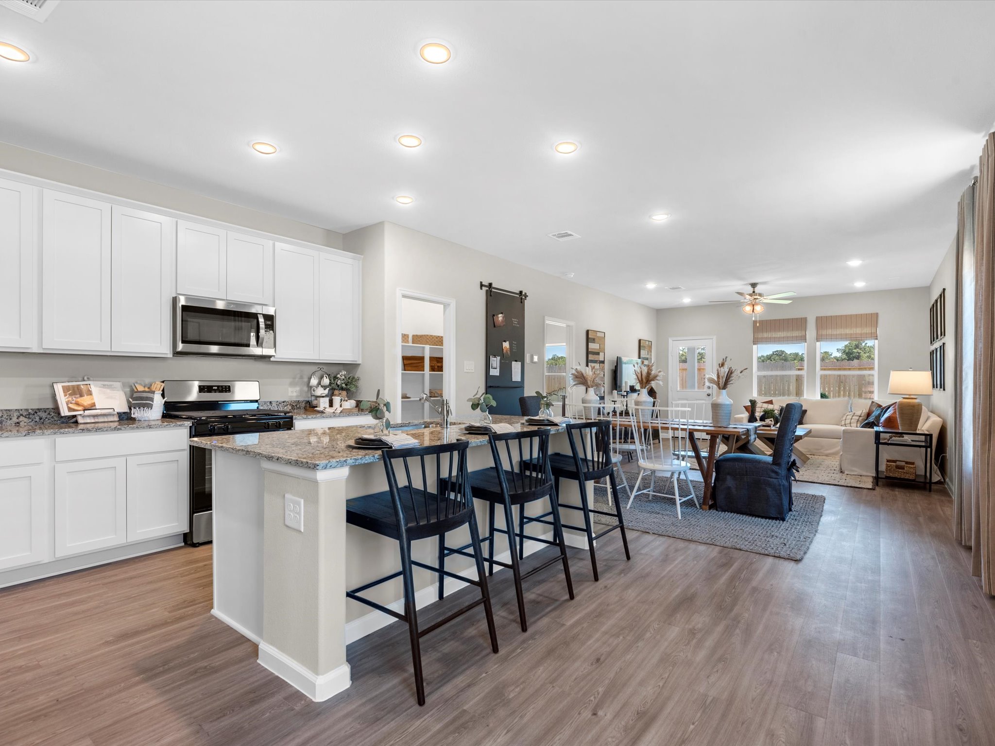 A kitchen with white cabinets.