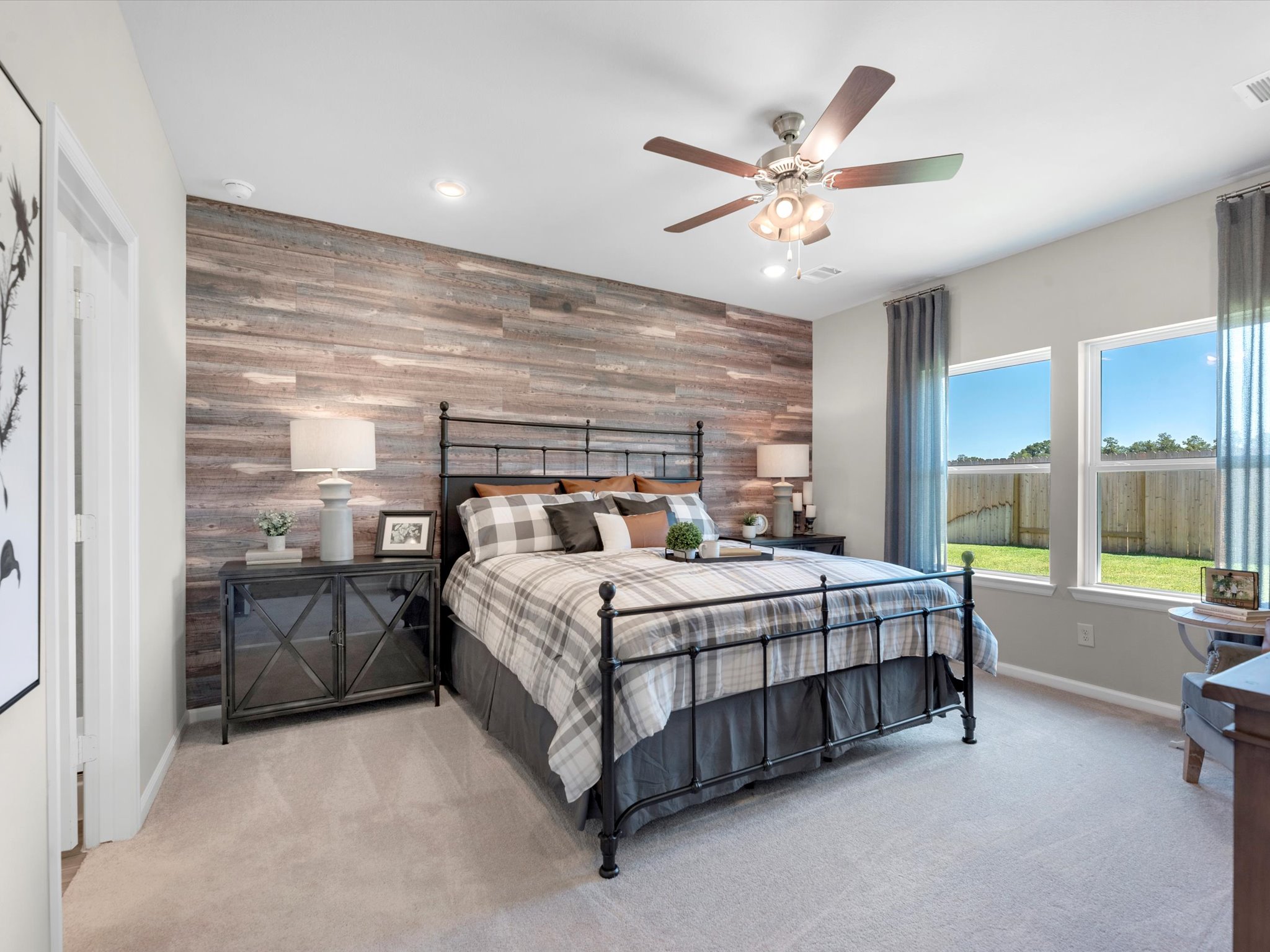 A bedroom with a bed and a fan.