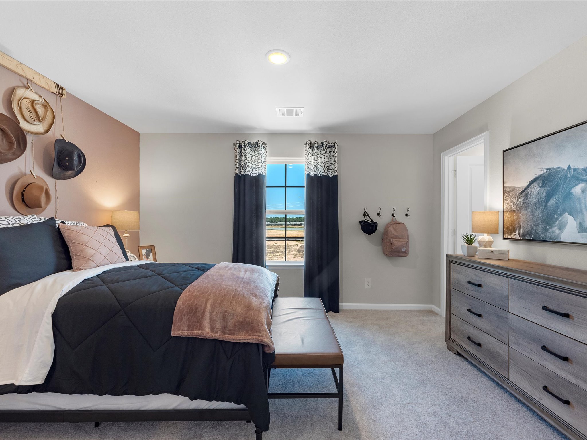 A bedroom with a bed and a chair.