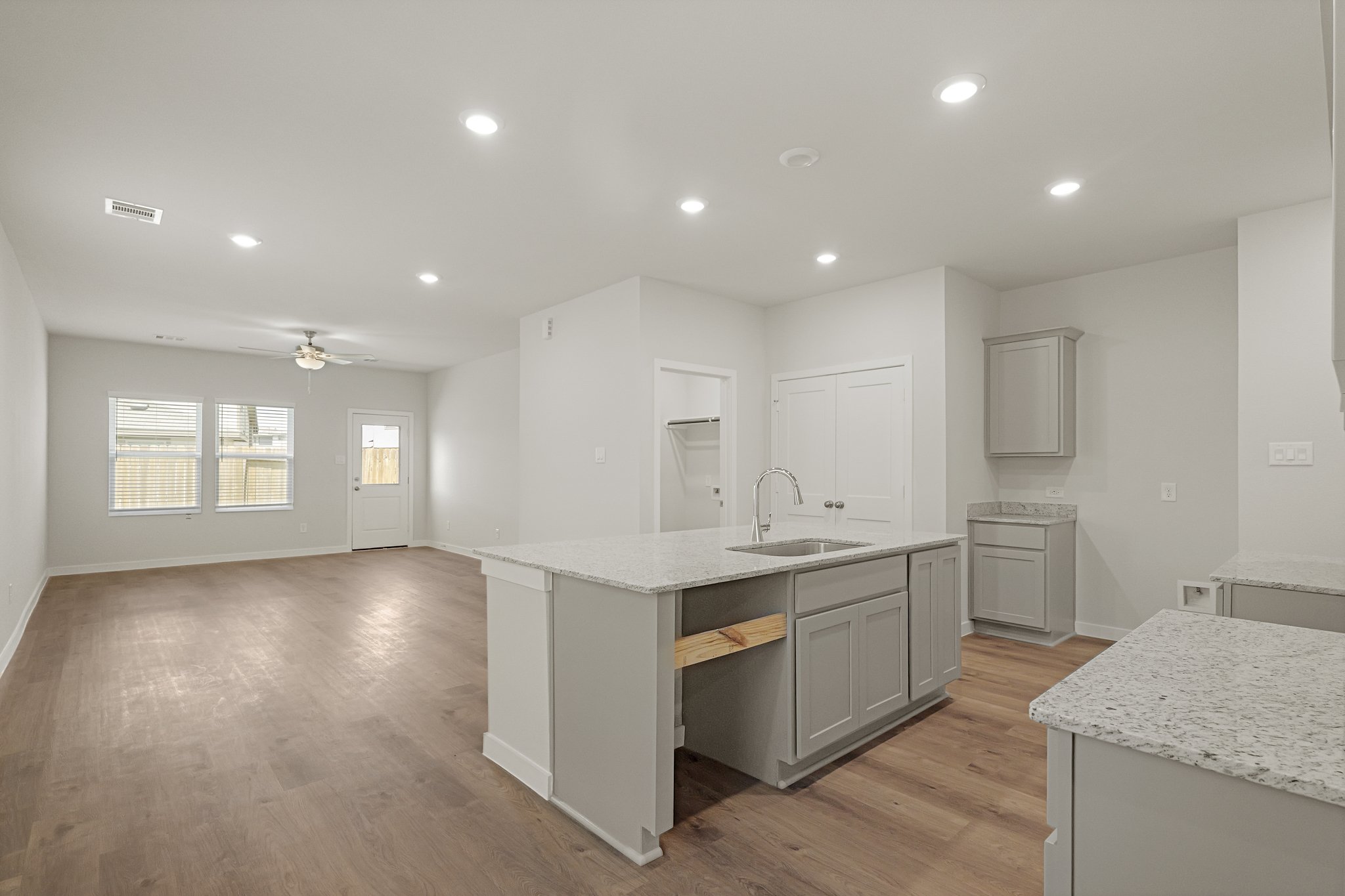 A kitchen with white cabinets.