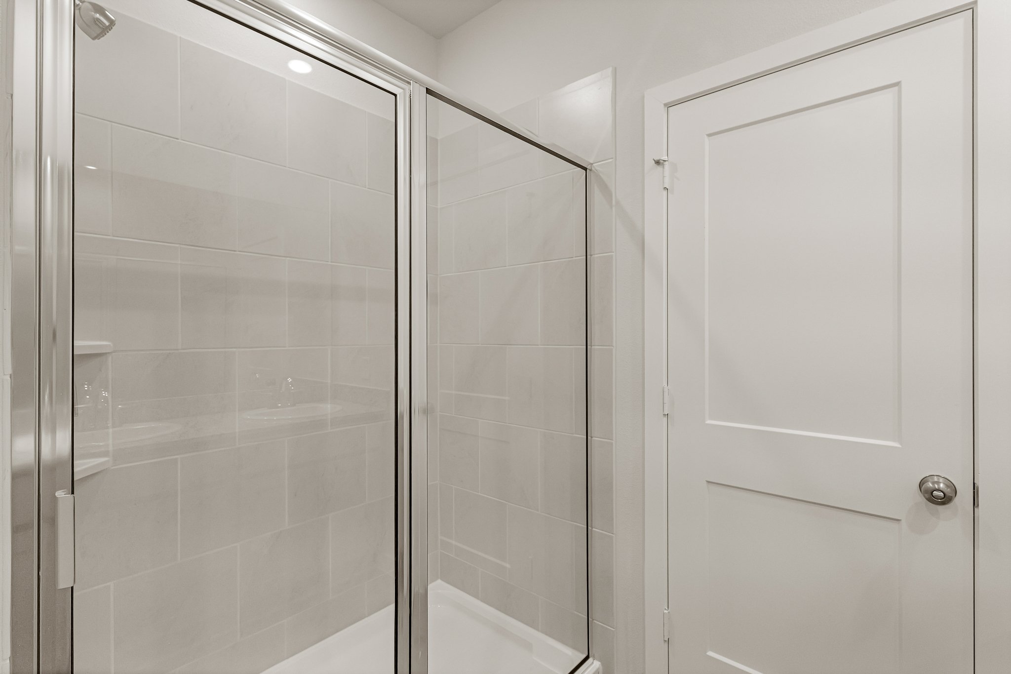 A shower with a glass door.