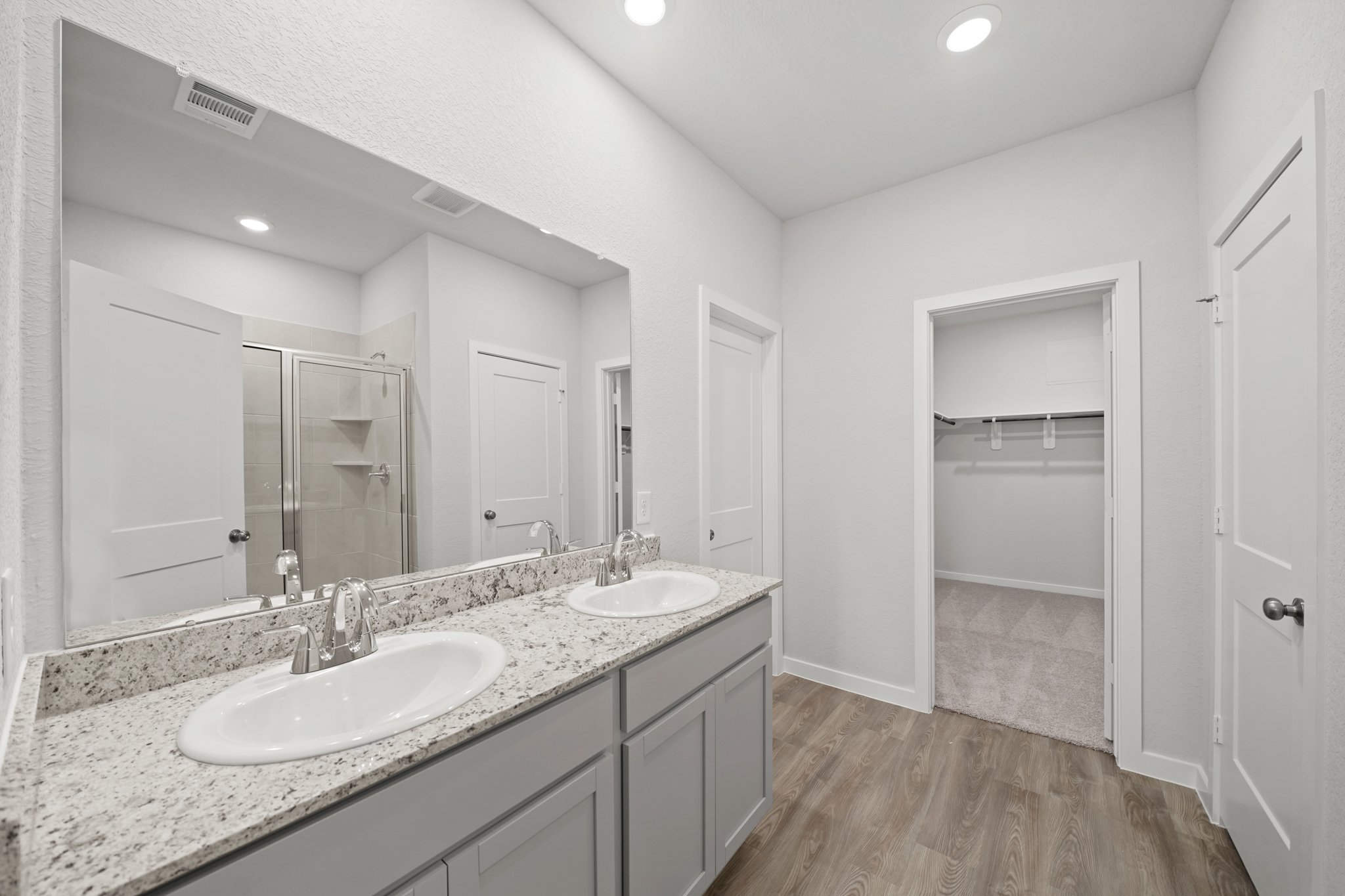 A bathroom with a large mirror.