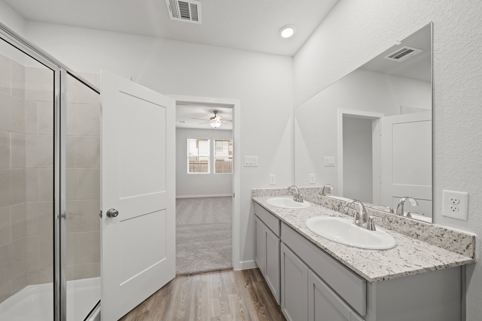 A bathroom with a large mirror.