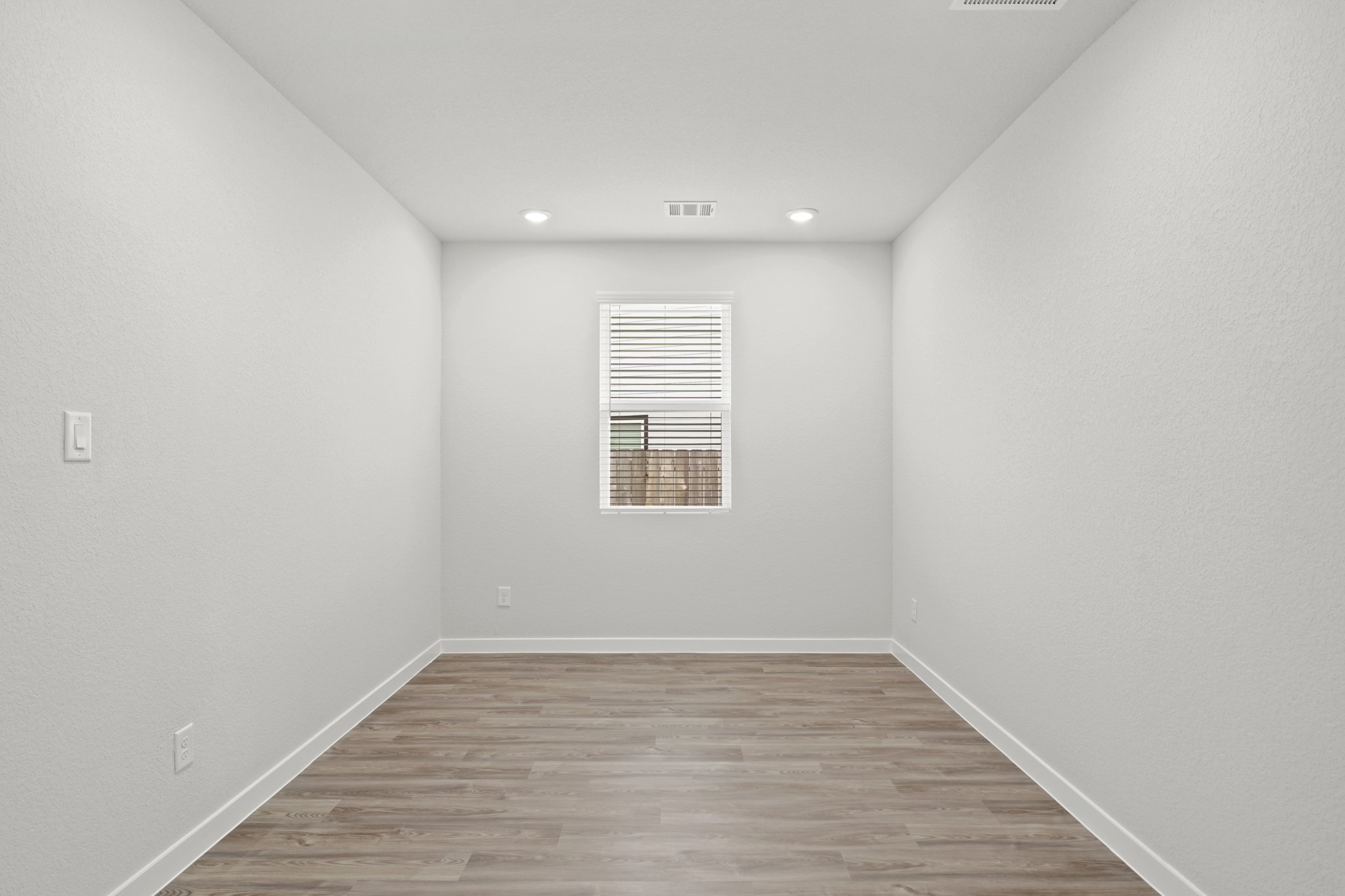 A room with a wood floor and a wood floor.