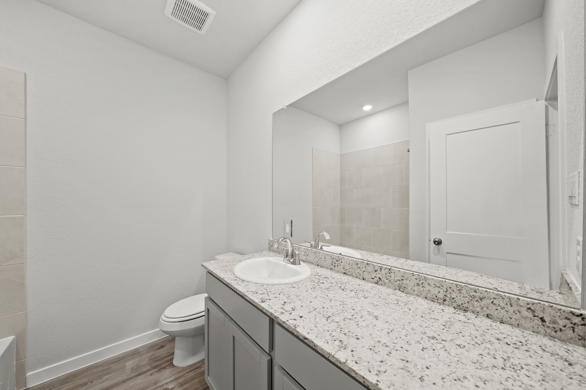 A bathroom with a marble countertop.