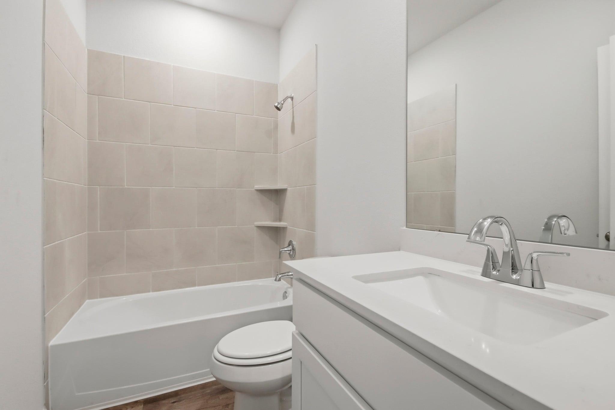 A bathroom with a tub sink and toilet.