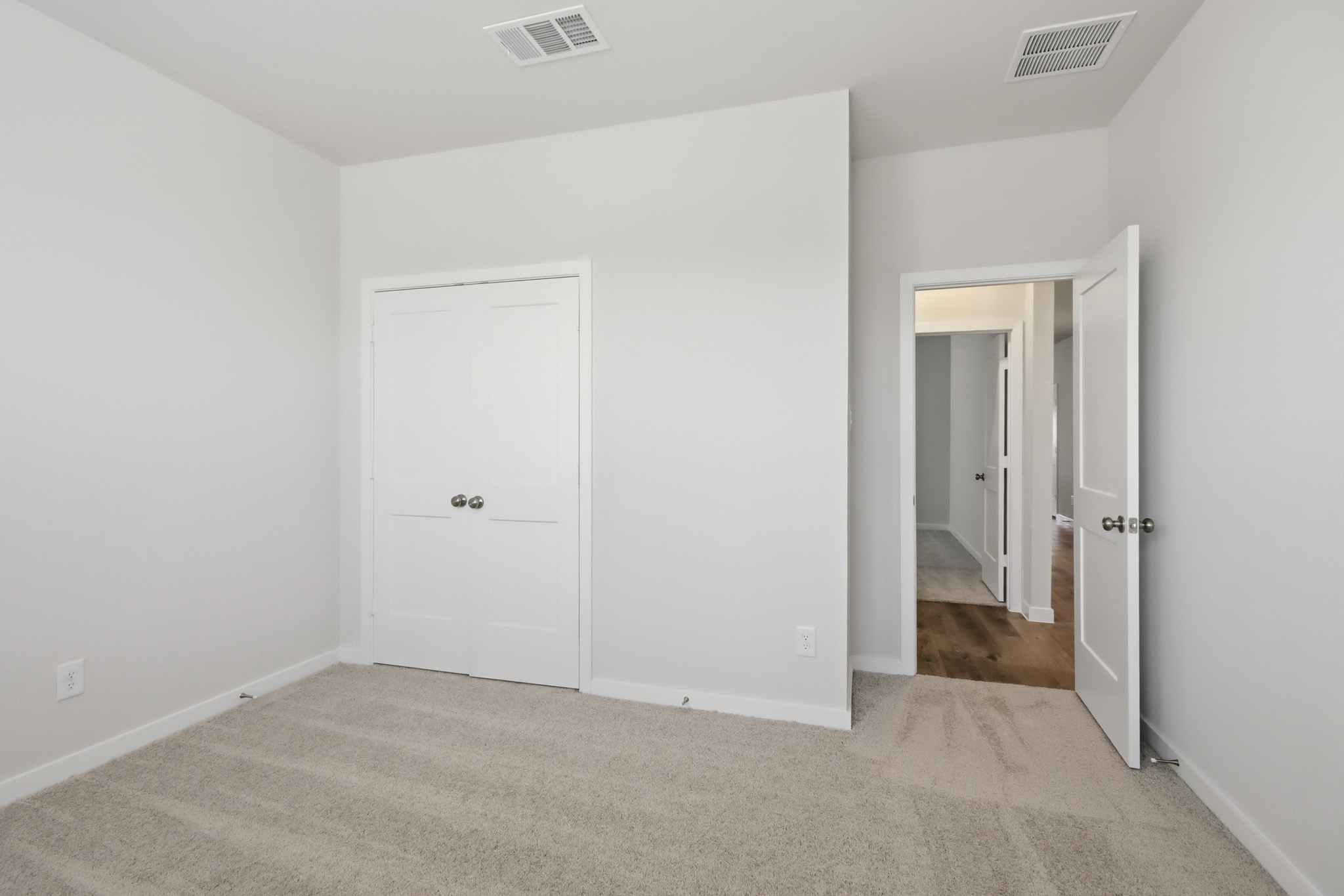 A hallway with white doors.