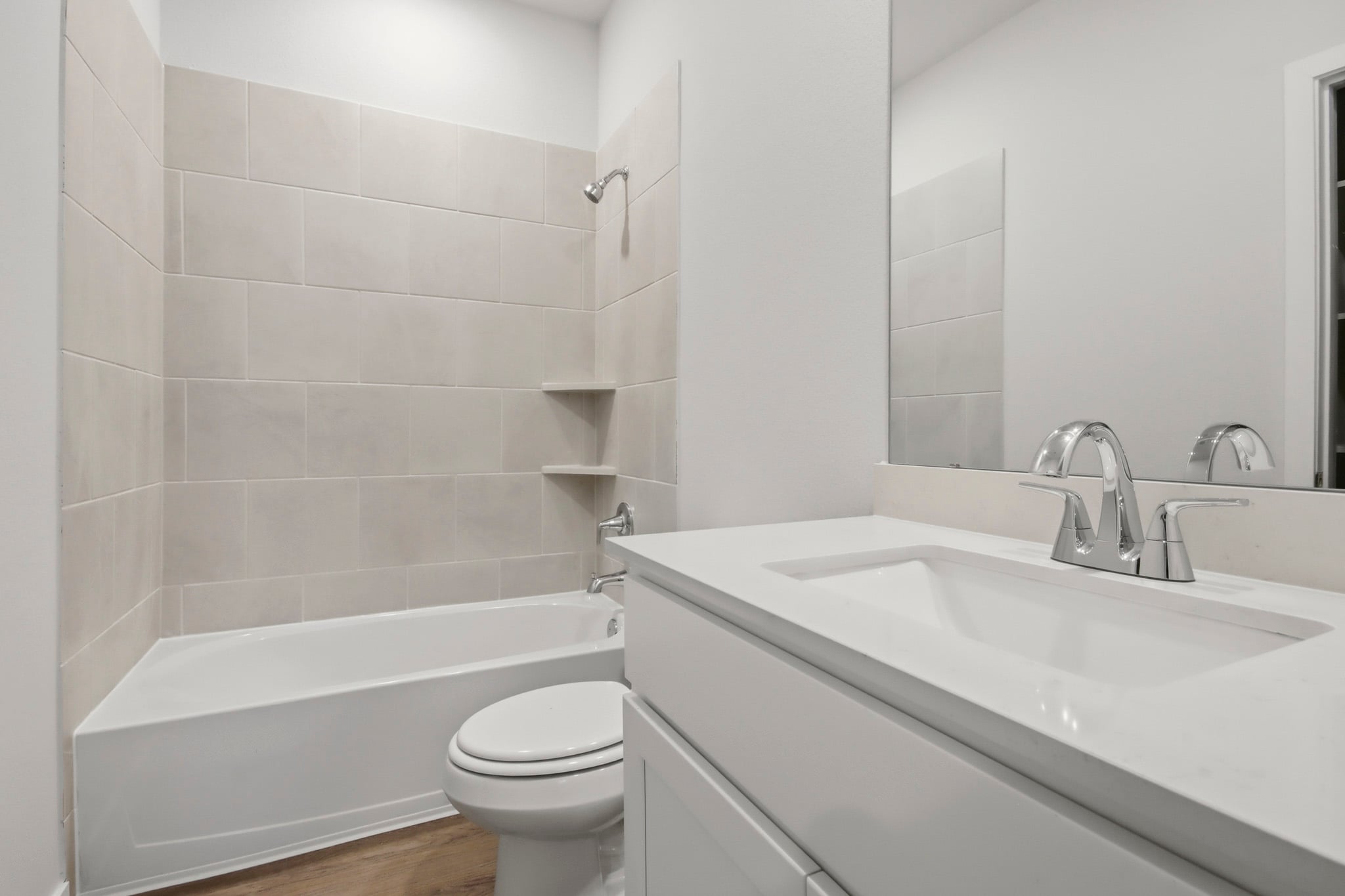 A bathroom with a tub sink and toilet.