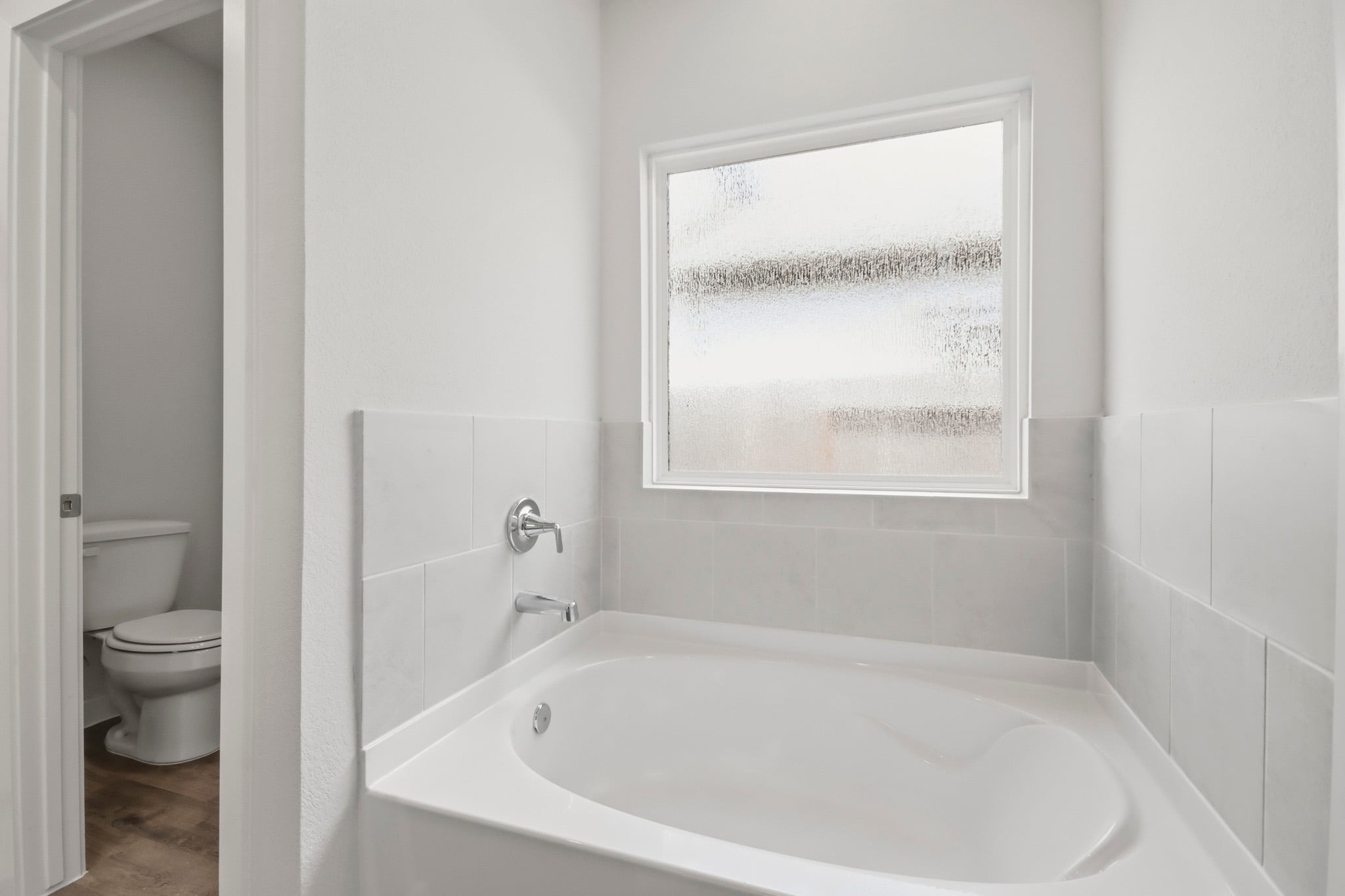 A bathroom with a tub and toilet.