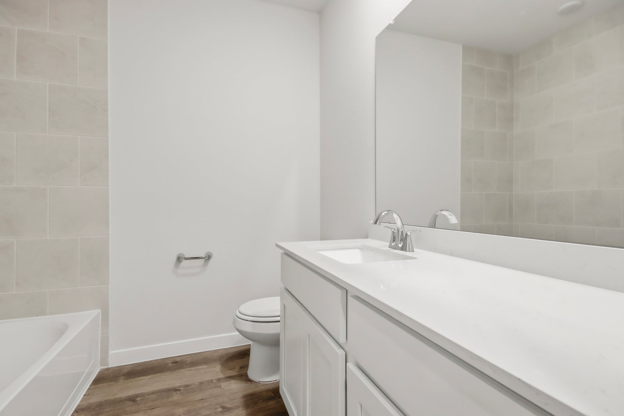 A bathroom with a tub sink and toilet.