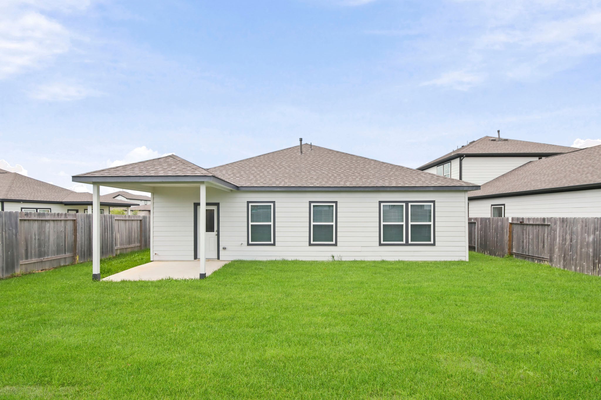 A house with a fence and grass.