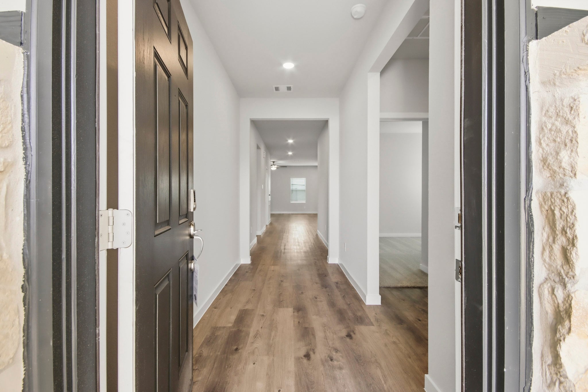A hallway with black doors.