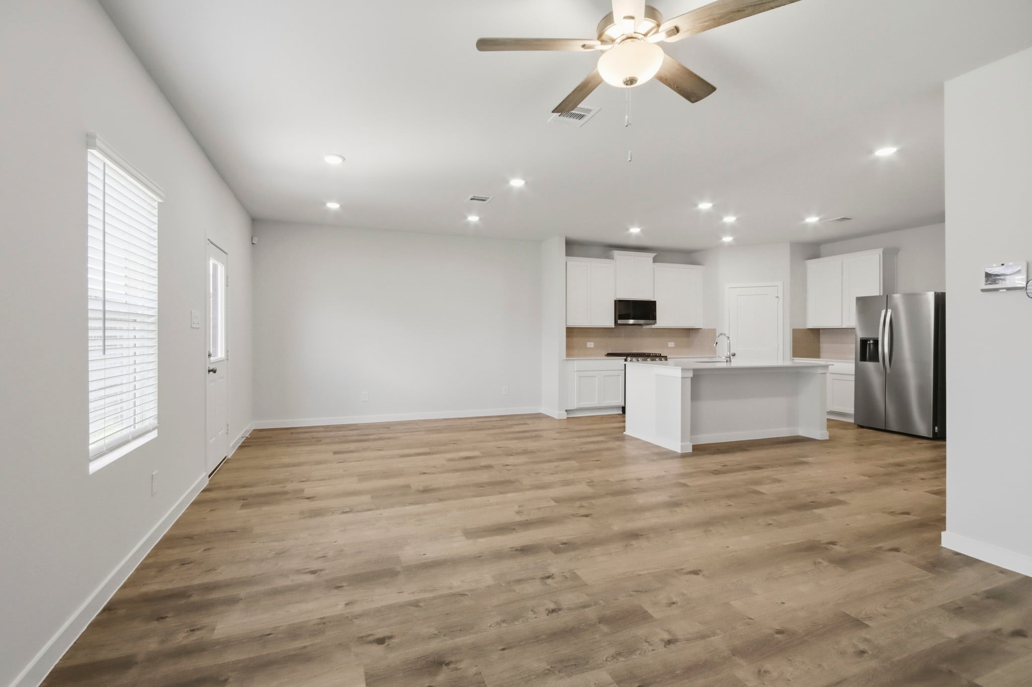 A kitchen with a wood floor.