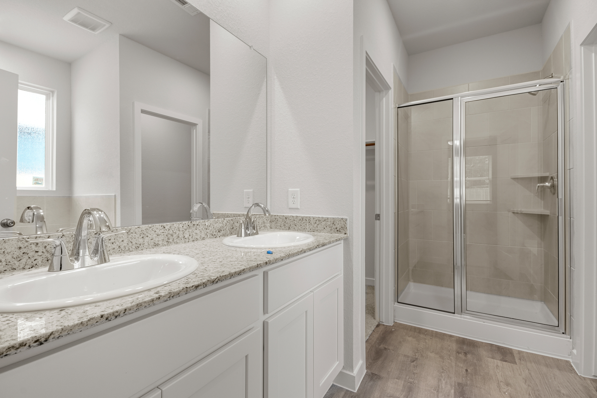 A bathroom with a glass shower.