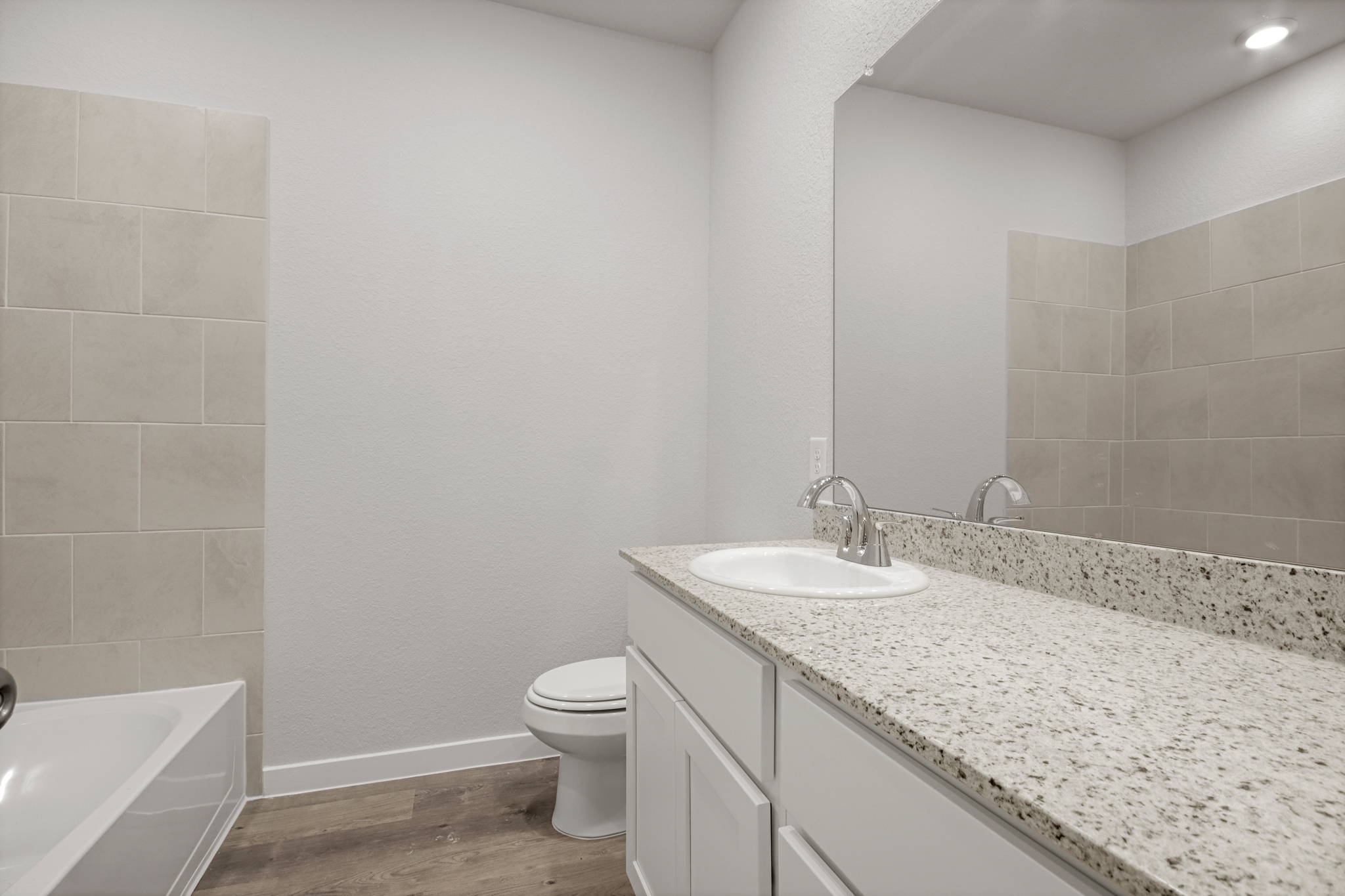 A bathroom with a marble countertop.