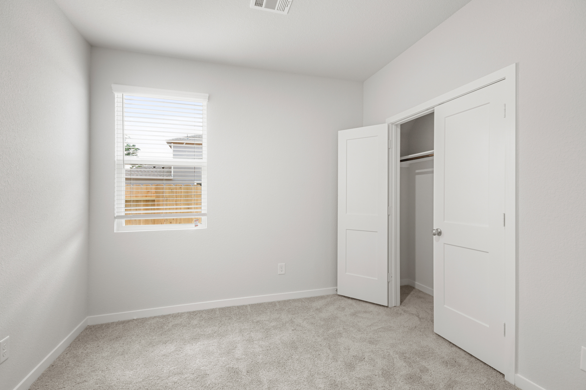 A room with white walls and a window.