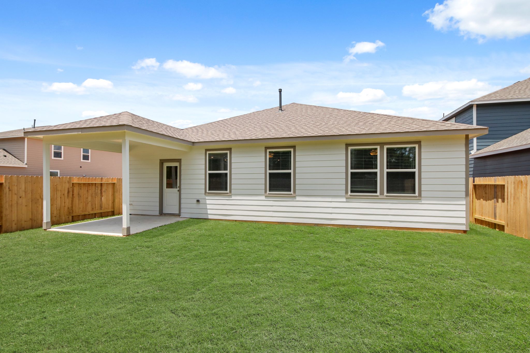 A house with a green lawn.