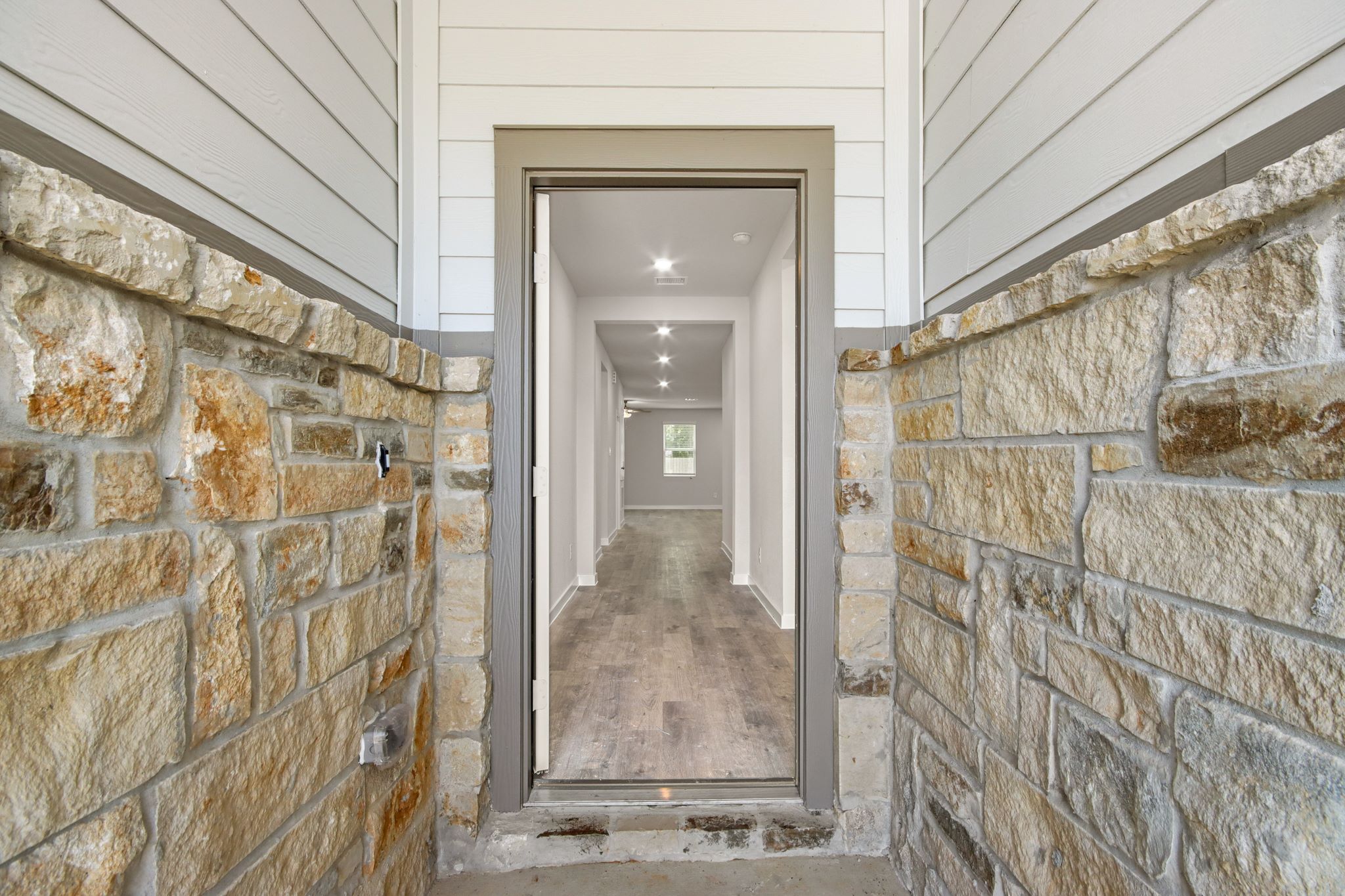 A stone hallway with a brick wall.